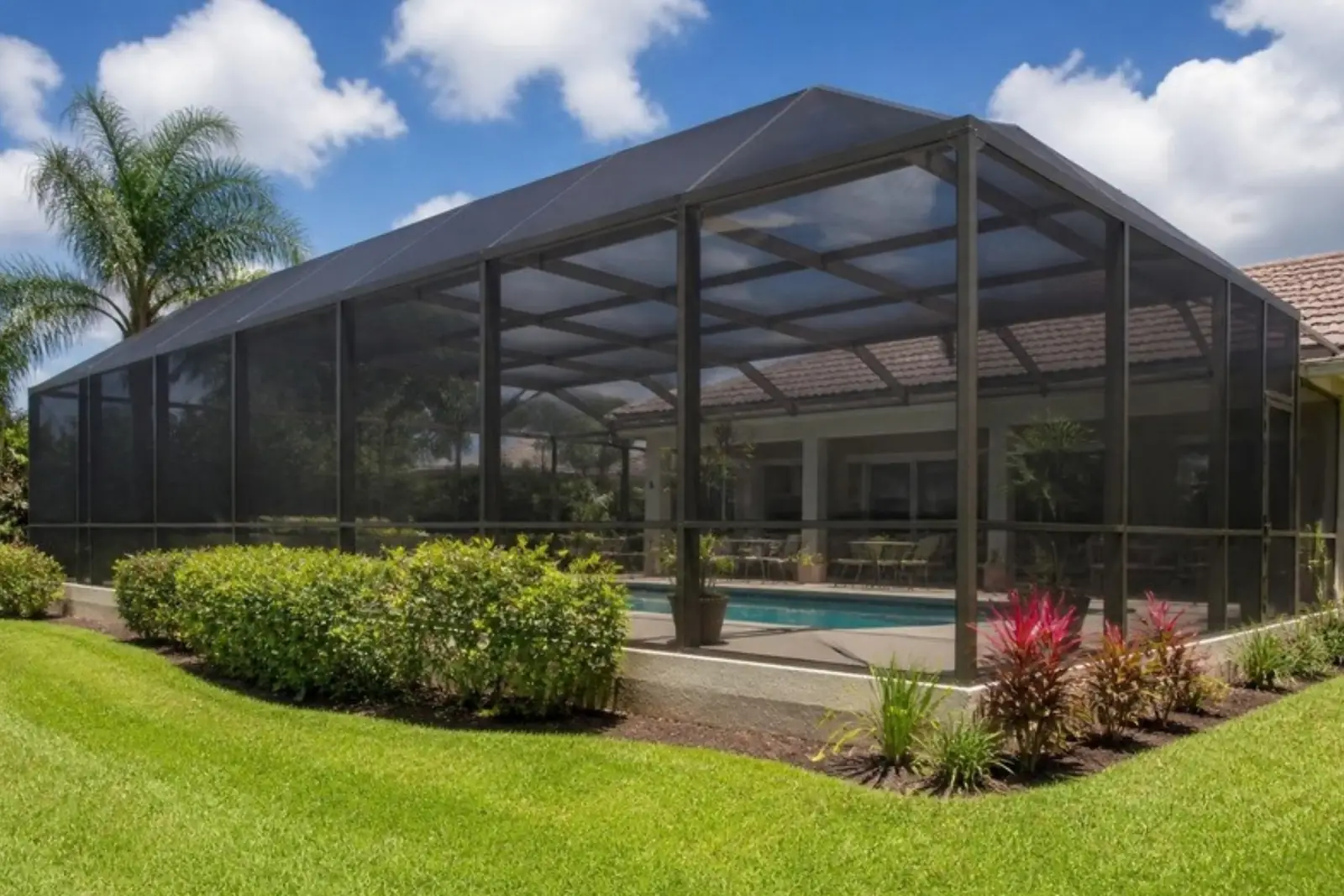 Pool screen enclosure over a patio
